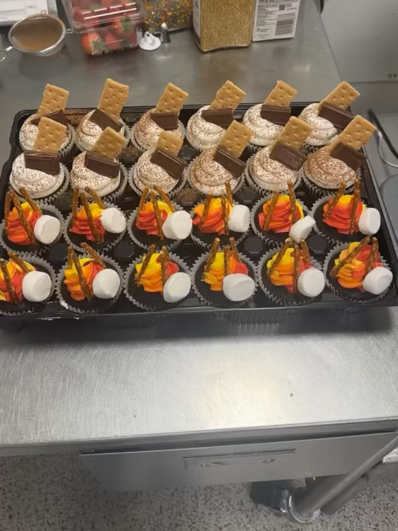 Fall-themed cupcakes topped with graham crackers, marshmallows, and orange candy