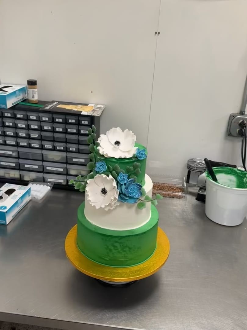 Small two-tier green cake with white flowers