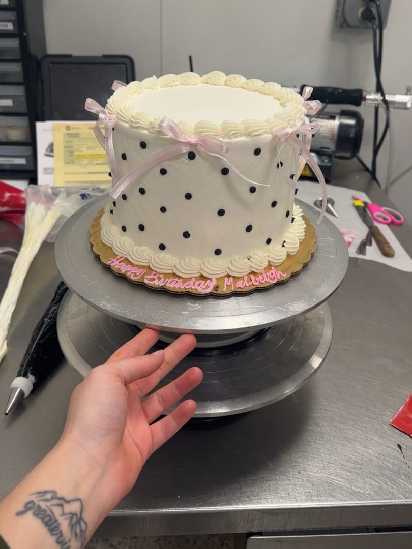 White cake with black polka dots and pink bows