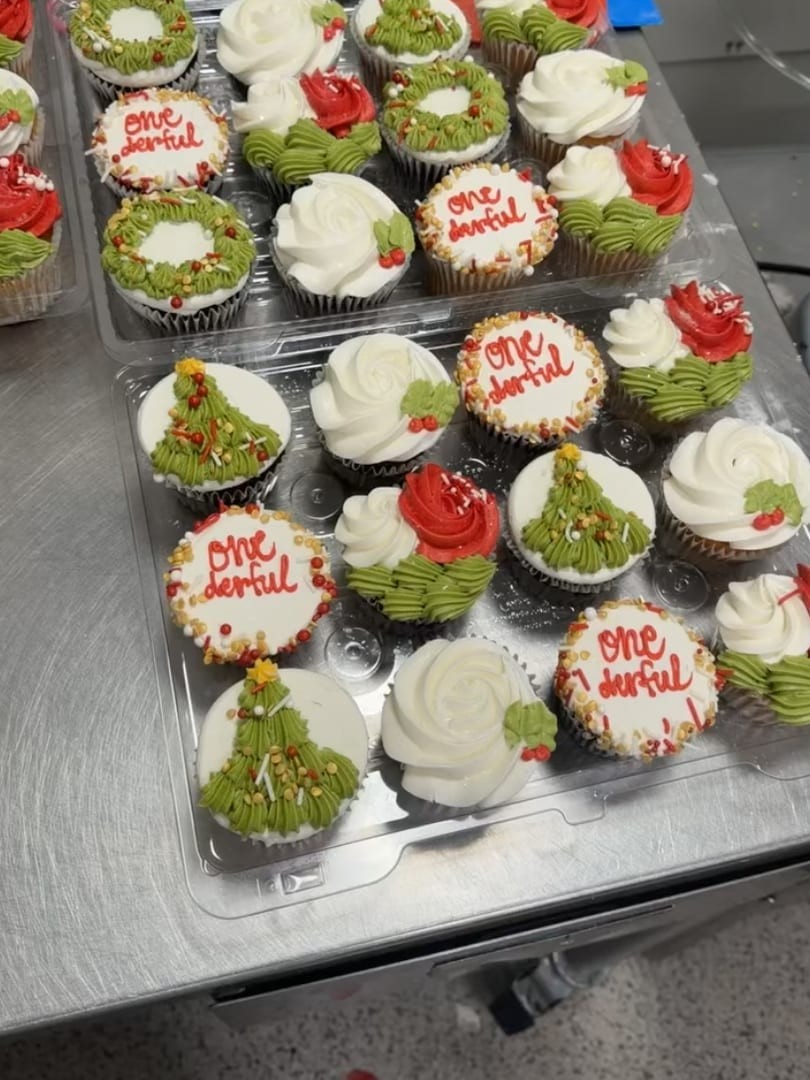 Holiday cupcakes with green trees and red and white decorations